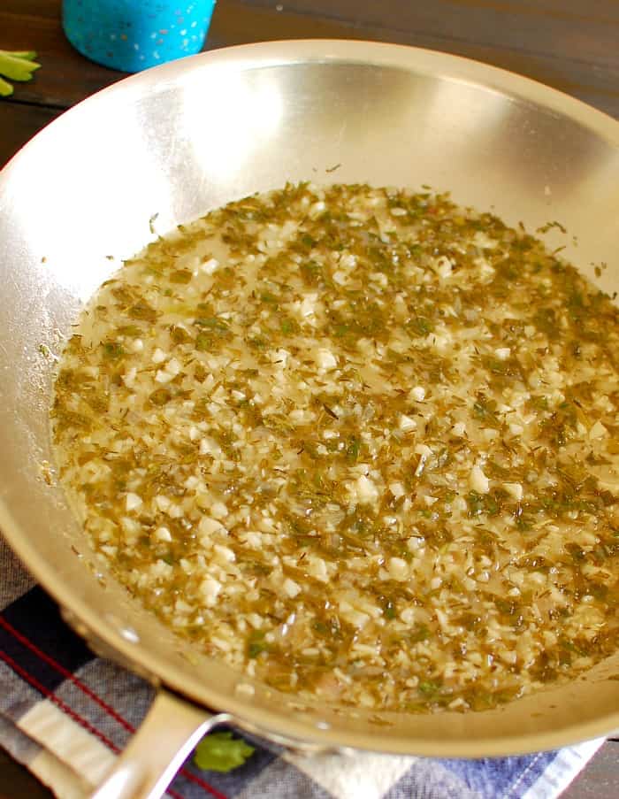 Garlic sauce with reduced wine in a skillet. 