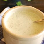 Creamy garlic sauce in a ceramic serving bowl.