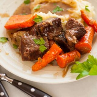 Braised short ribs slow cooked in Guinness stout until the meat is super tender and flavorful. | joeshealthymeals.com