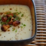 Close-up of a bowl if cauliflower soup with browned florets.