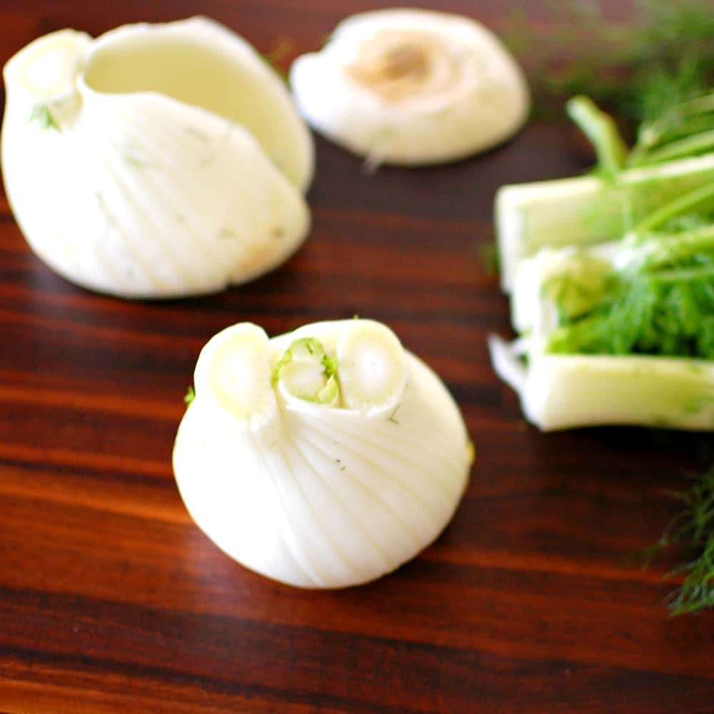 Cleaning a fennel bulb.