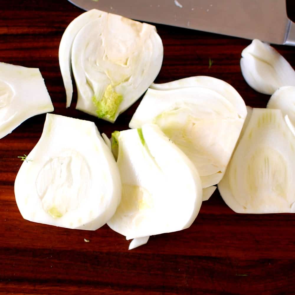 Sliced fennel on a cutting board.