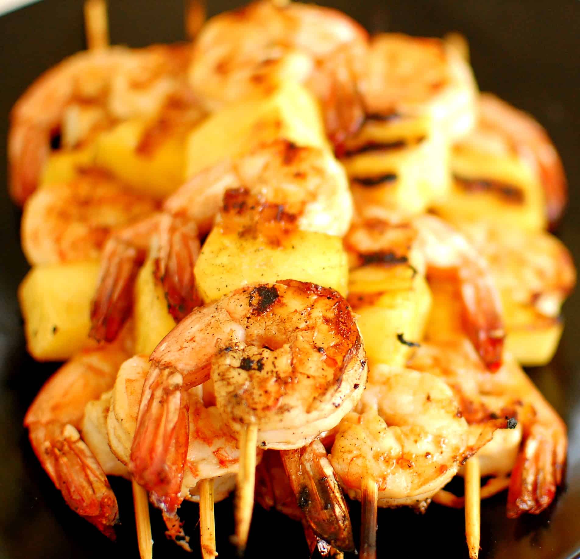 Close-up view of grilled shrimp on skewers.