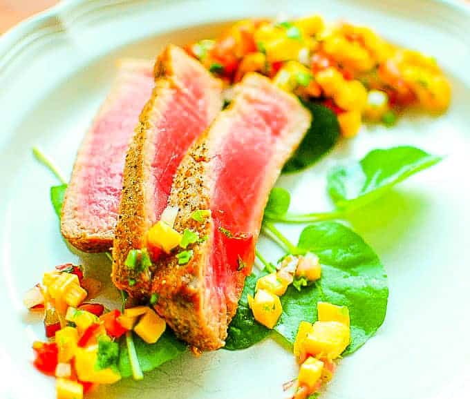 Rhubarb mango salsa with seared tuna on a plate.