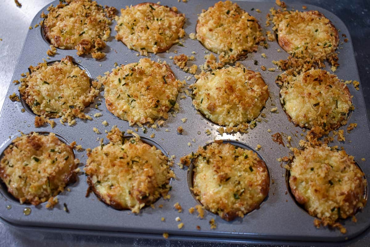 Twelve mini crab cakes after baking in the oven.