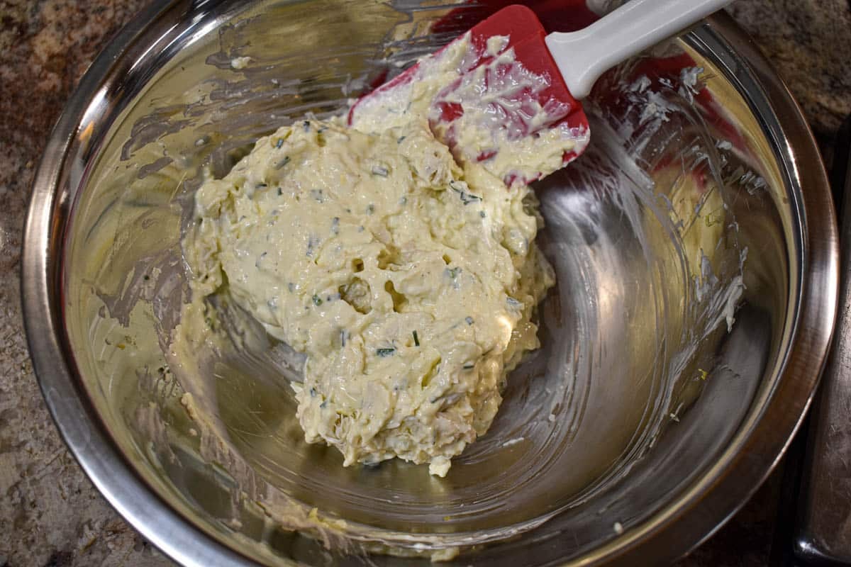 A bowl of crab meat mixed with the cream cheese.