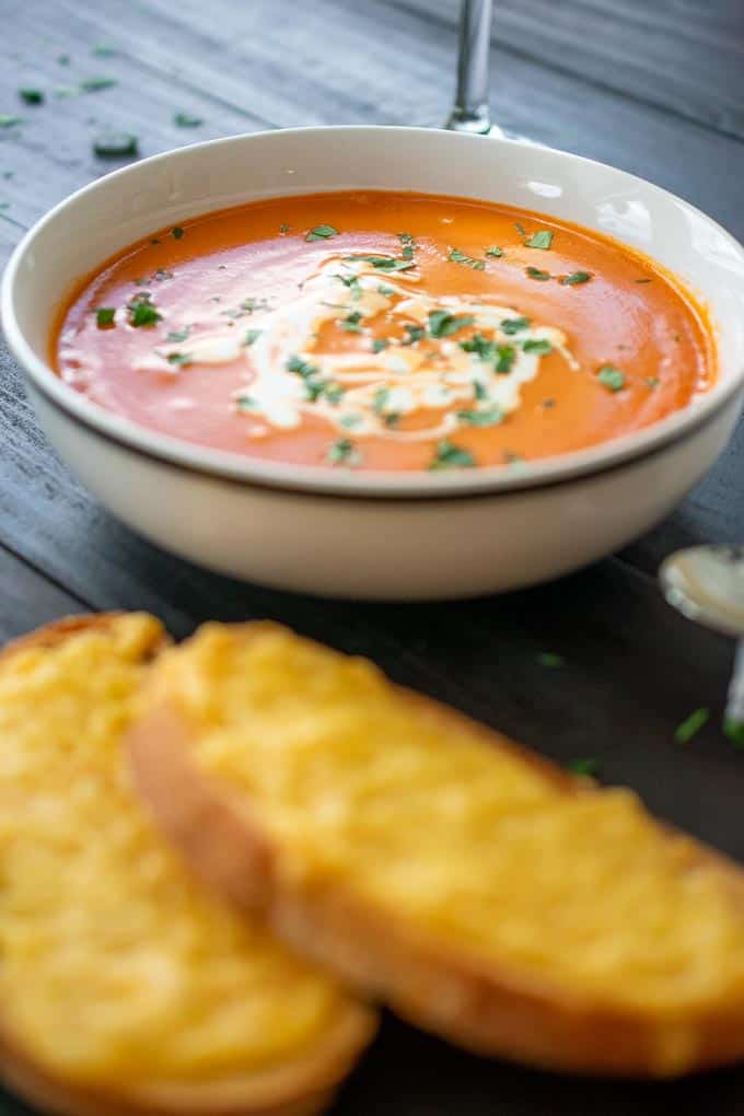 bowl of tomato bisque with cheesy bread