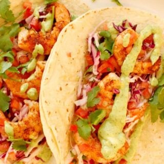 Shrimp taco on a plate.