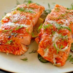 2 salmon filets on a plate ready to eat.