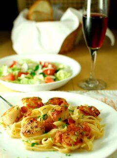 Seared scallops with garlicky pasta. Tasty seared scallops with a simple garlicky, white wine sauce. | joeshealthymeals.com