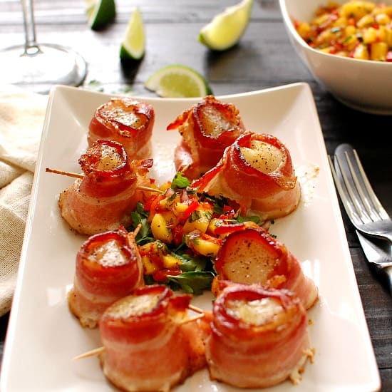 Bacon wrapped scallops with mango salsa. Delicious appetizer or as a main course.