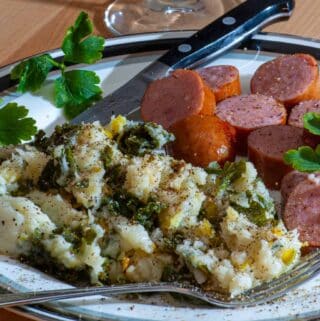 Irish colcannon with sausage on a plate.