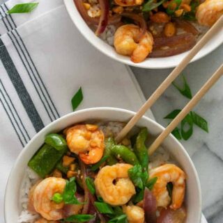 Overhead view of 2 bowls of shrimp stir fry.