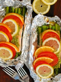 Pesto salmon with asparagus in foil. Healthy, easy way to cook your salmon. Coat the salmon with pesto and place it on top of some asparagus and bake at 400° for 25 to 30 minutes. Yum. | joeshealthymeals.com
