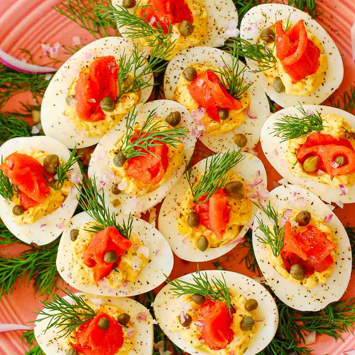 Deviled eggs on a platter with fresh dill weed.