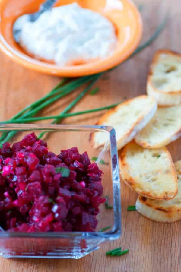 Beet tartare in a bowl with toasted baguette.