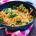 Skillet of pork, vegetables, and rice noodle stir fry.