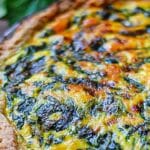 A quiche made with potatoes, spinach, and parmesan cheese.