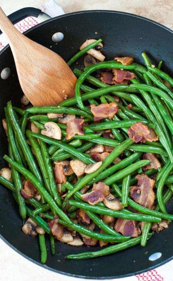 Skillet with bacon mushrooms and green beans.