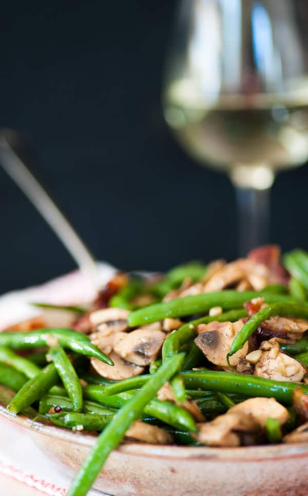 Green beans mushroomsbacon on a plate.