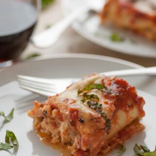 Lasagna roll-up on a plate.