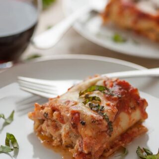 Lasagna roll-up on a plate.