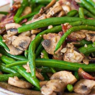 Green beans bacon and mushrooms on a plate.