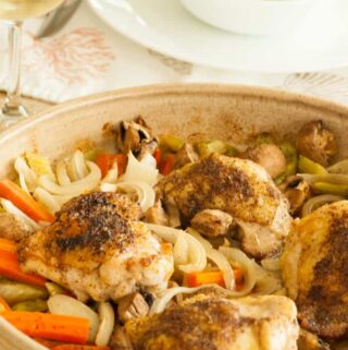 Baked chicken thighs with vegetables. Super easy recipe for a busy family and the flavor is outstanding! | joeshealthymeals.com