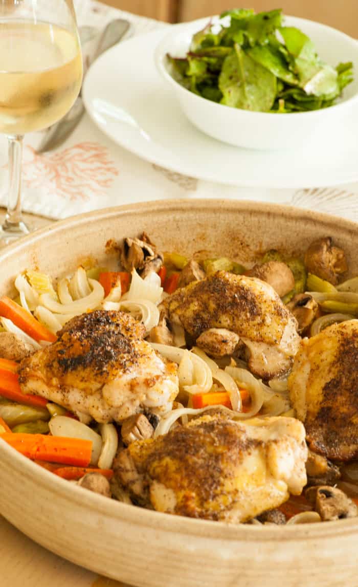 Baked chicken thighs with vegetables. Super easy recipe for a busy family and the flavor is outstanding! | joeshealthymeals.com