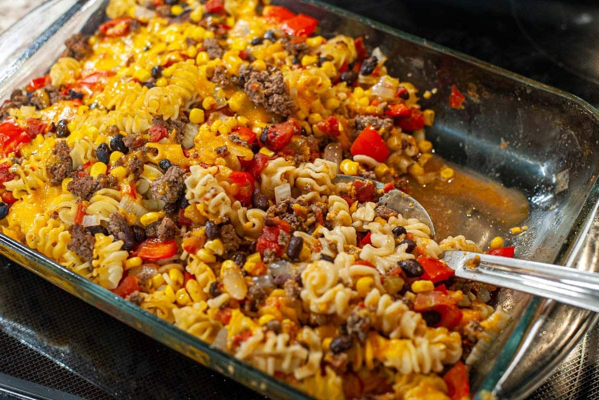 Mexican casserole with a serving spoon.