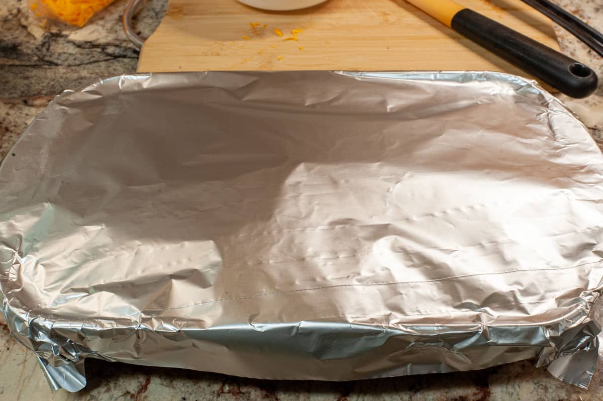 Casserole with aluminum foil covering.