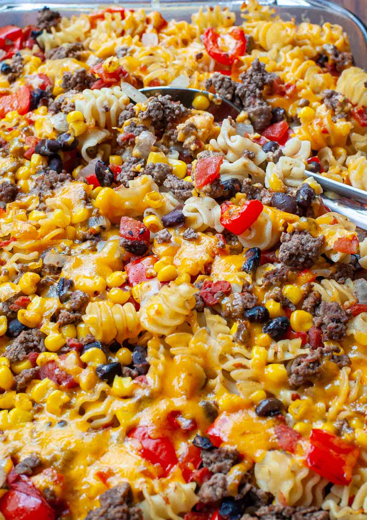 Ground beef casserole with a serving spoon.