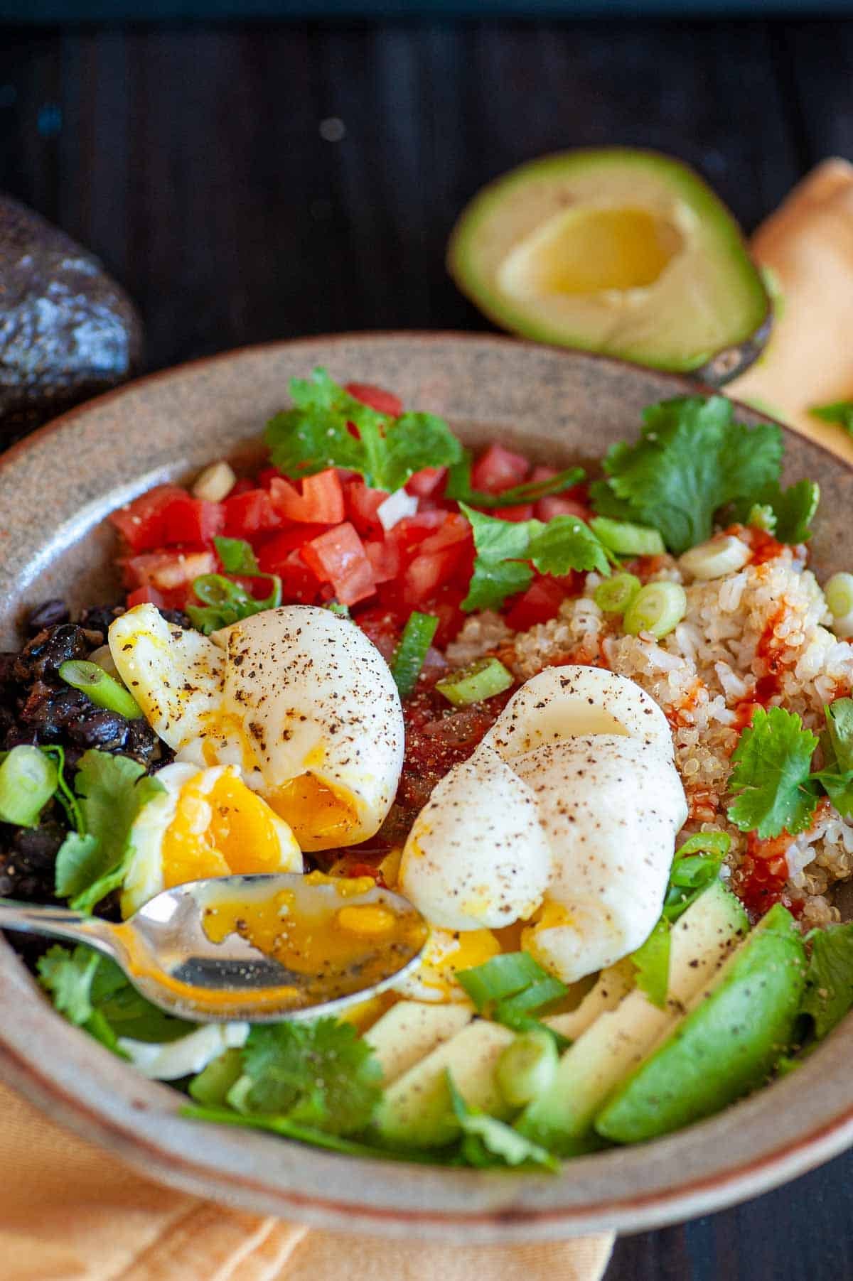 Tex-Mex quinoa bowl with soft boiled eggs.