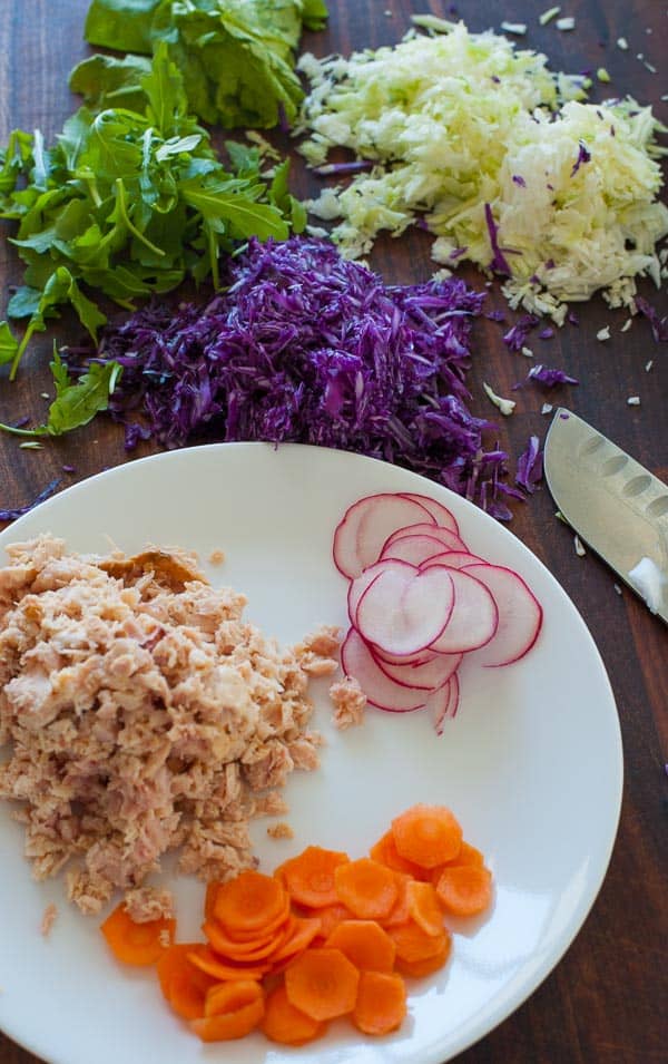 Tuna salad ingredients on a cutting board.