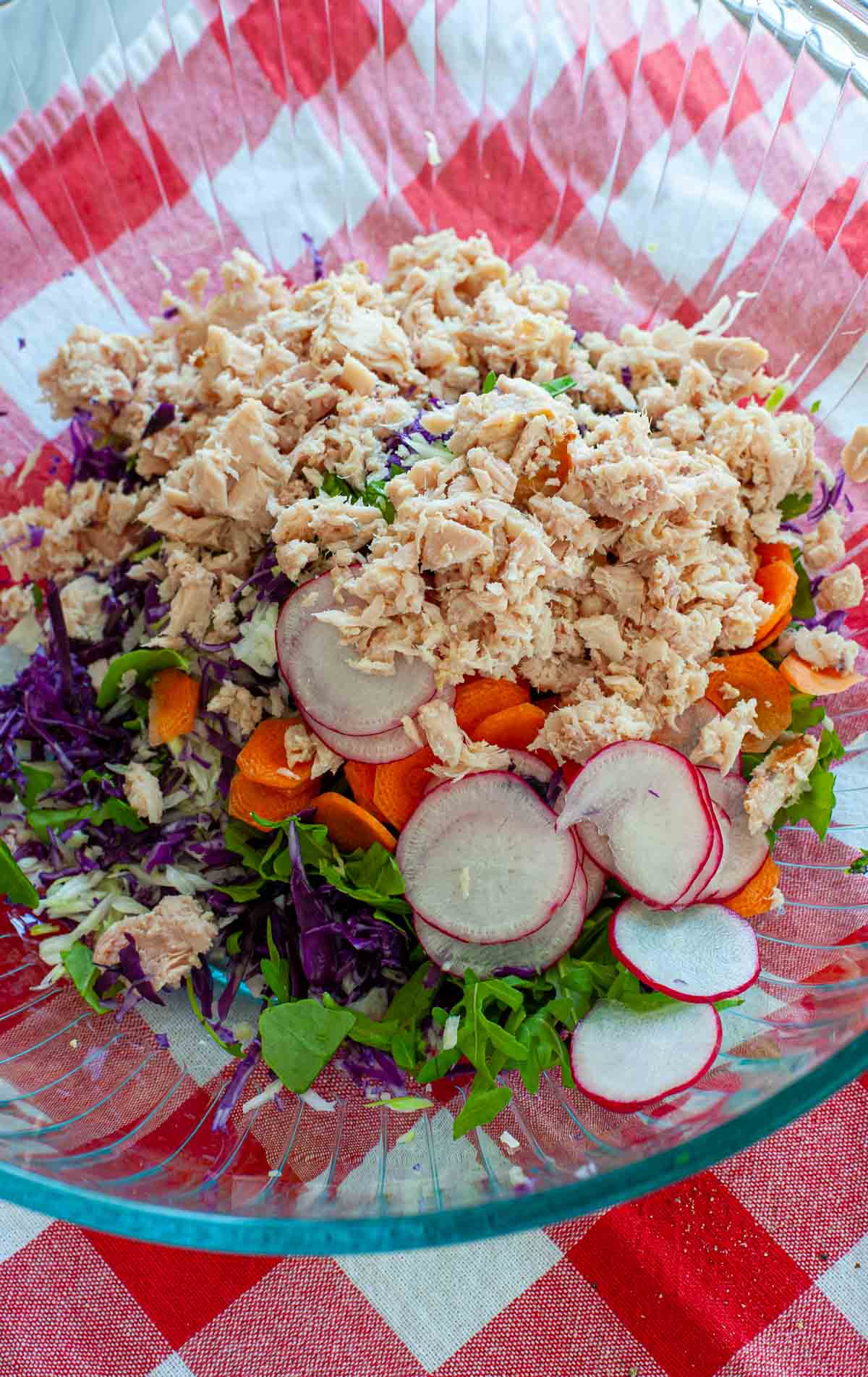 Tuna salad in a bowl ready to be mixed together.