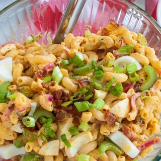 Macaroni deviled egg salad in a bowl. Delicious salad that everyone will love. Its deviled eggs in a bowl. | joeshealthymeals.com