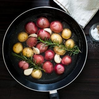 Braised baby potatoes with rosemary and garlic. Less than 30 minutes for a pan braised potato side dish. Easy and yummy. | joeshealthymeals.com