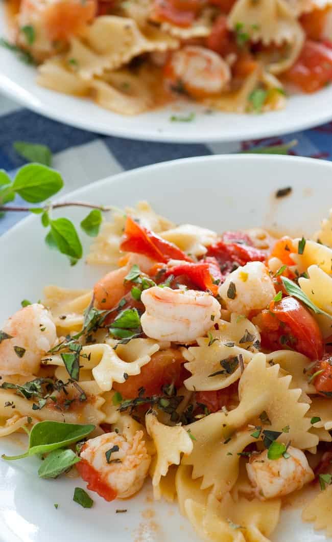 Close-up view of pasta with Roma tomatoes and shrimp sauce. 