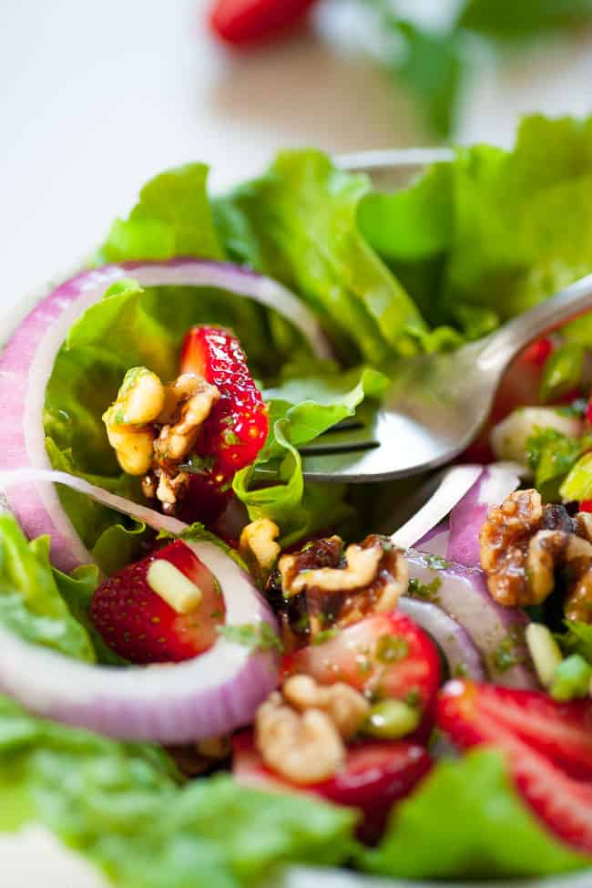 Fresh greens salad with basil mint vinaigrette close up view. 