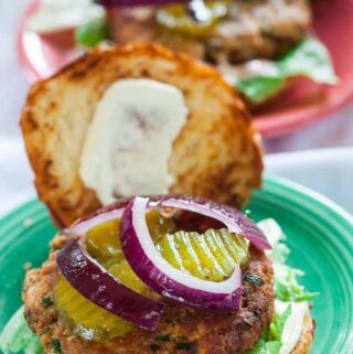 Salmon patty sandwiches on toasted buns.