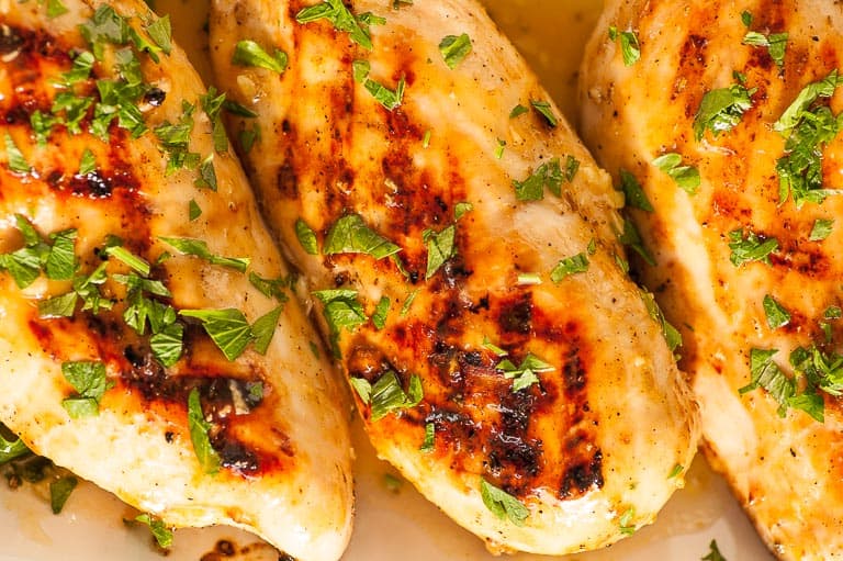 Overhead close-up view of 3 chicken breasts.