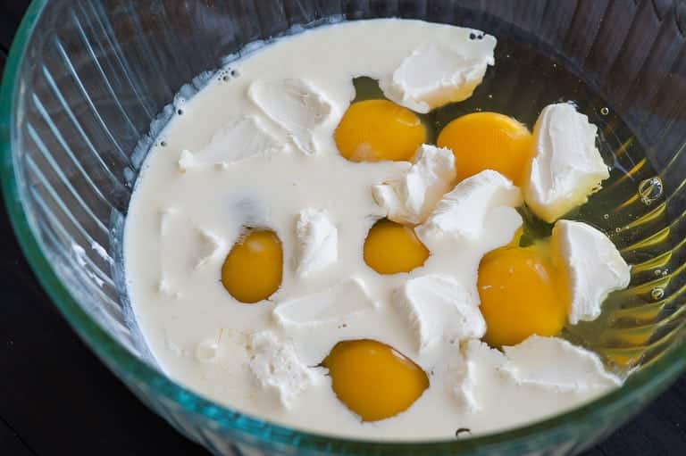 Eggs and cream in a bowl ready to whisk.