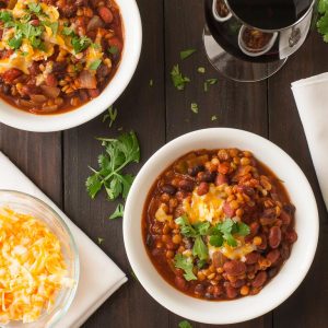 Overhead view of 2 bowls of chili.