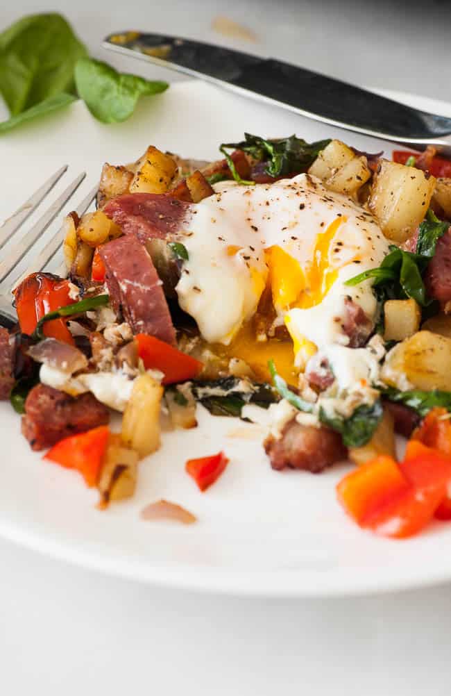 Breakfast hash with fried egg on a plate.