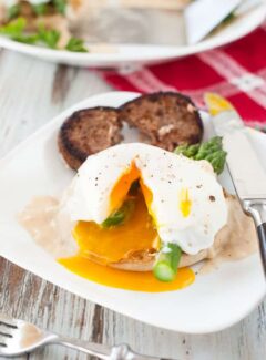 Poached egg breakfast muffin with asparagus and cheesy white sauce. | joeshealthymeals.com