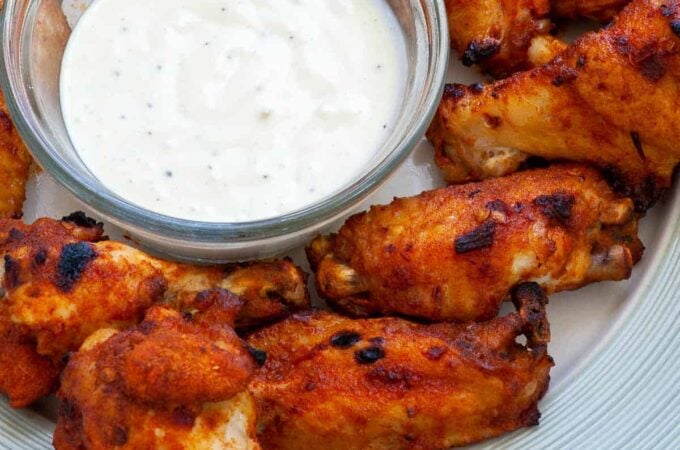 Plate of chicken wings and ranch dip.