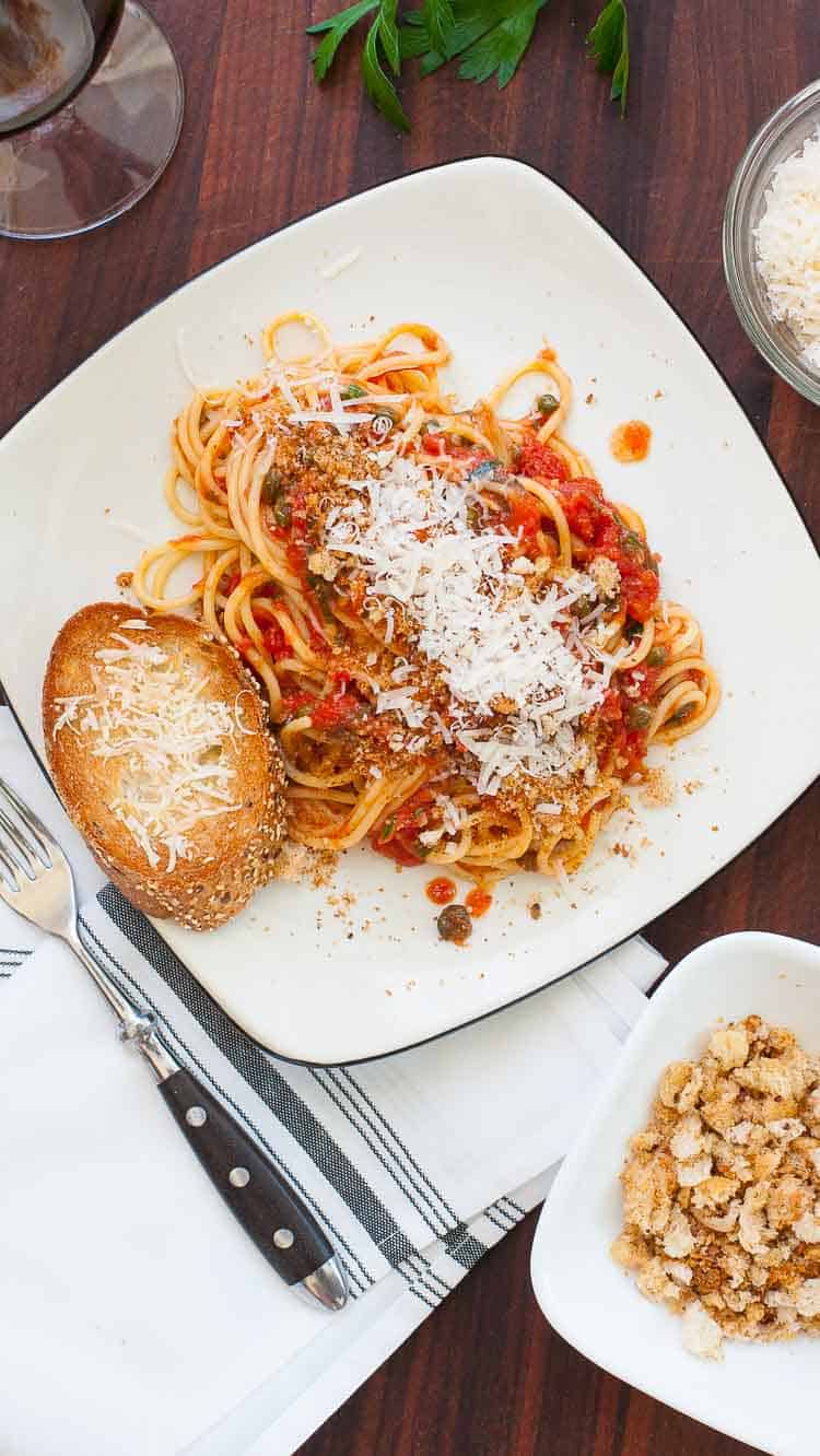 Midnight spaghetti recipe with grated parmesan on a plate.