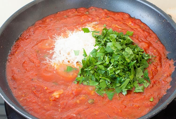 Cheese and parsley are added last to the skillet.