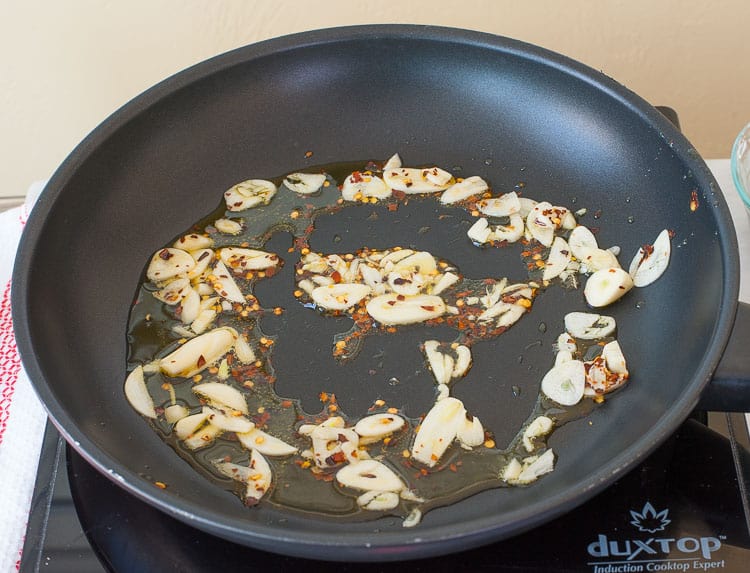 Lots of garlic and red pepper in a skillet.