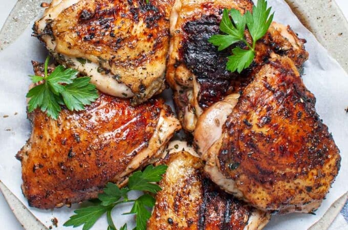 Chicken thighs on a plate.